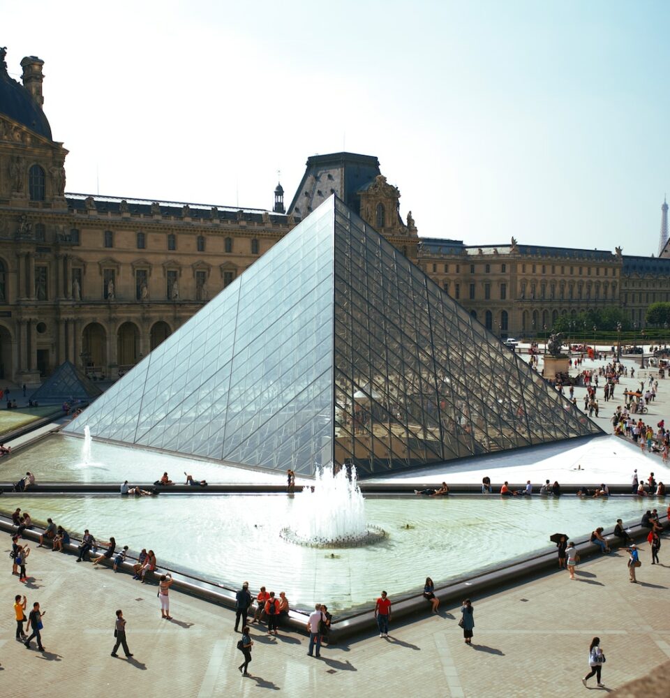 people walking around pyramid landmark